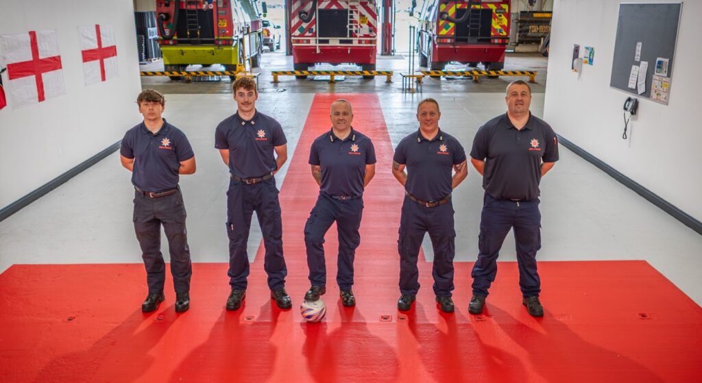 Blackpool Airport firefighters have transformed their station into a mini England fan zone - rolling out a giant St George's Cross and decorating the walls with their club shirts.