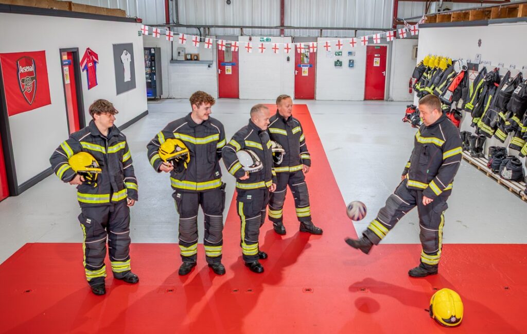 Blackpool Airport firefighters have transformed their station into a mini England fan zone - rolling out a giant St George's Cross and decorating the walls with their club shirts.