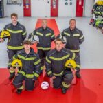 Blackpool Airport firefighters have transformed their station into a mini England fan zone - rolling out a giant St George's Cross and decorating the walls with their club shirts.