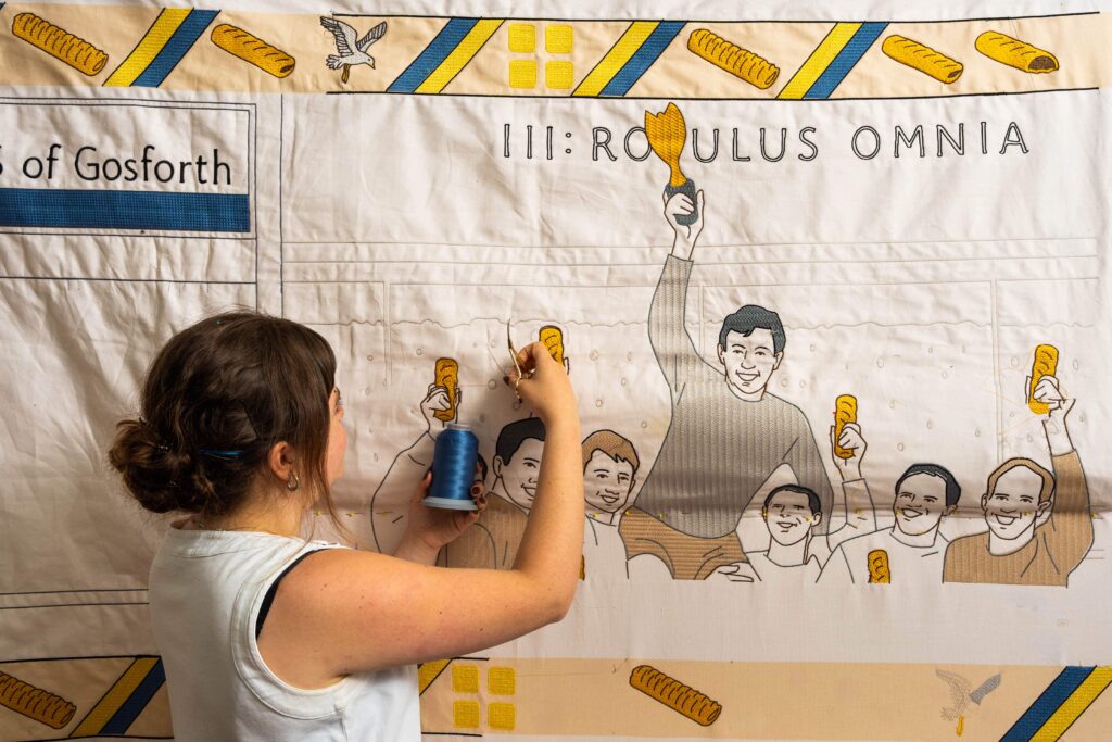 Greggs has unveiled a Bayeux Tapestry-inspired Ta-Pastry with 5.5 million stitches tracing the sausage roll's near-century history, on display at London's Design Museum.