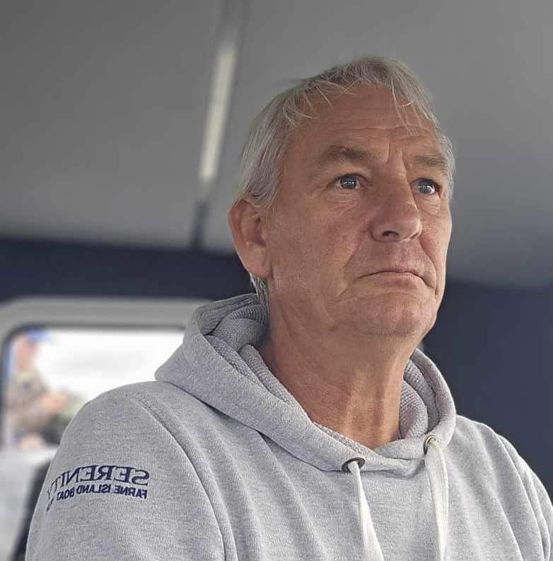 Around 20 killer whales from multiple pods stunned boat passengers off Northumberland's Farne Islands, with one orca performing a rare and spectacular breach.