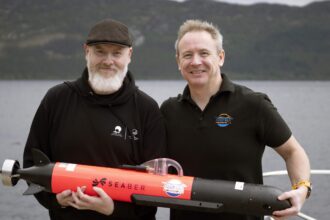 Hi-tech underwater robot searching Loch Ness successfully tracks down iconic Nessie film prop hidden beneath murky depths as monster hunters descend from around the world.
