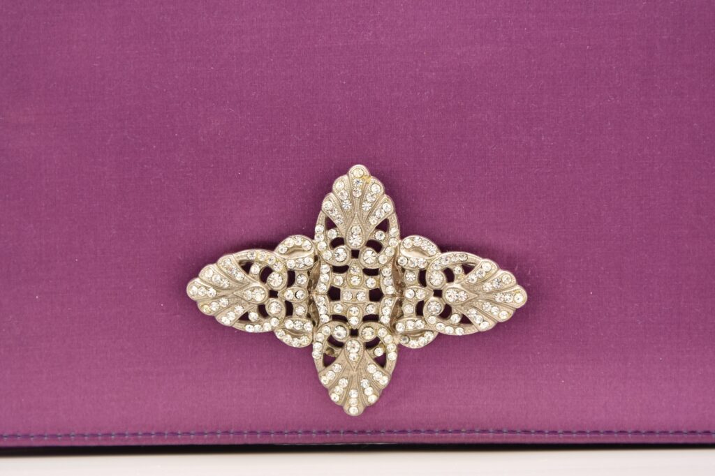 A mauve satin evening clutch owned by Margaret Thatcher - the accessory that spawned the term "handbagging" - is heading to auction with a £6,000 estimate.