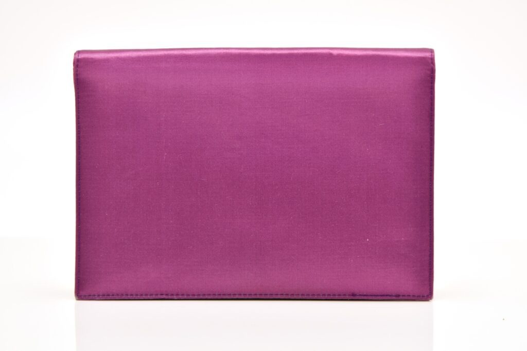 A mauve satin evening clutch owned by Margaret Thatcher - the accessory that spawned the term "handbagging" - is heading to auction with a £6,000 estimate.