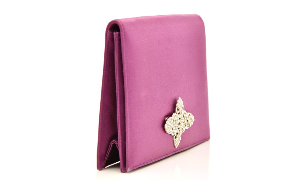 A mauve satin evening clutch owned by Margaret Thatcher - the accessory that spawned the term "handbagging" - is heading to auction with a £6,000 estimate.