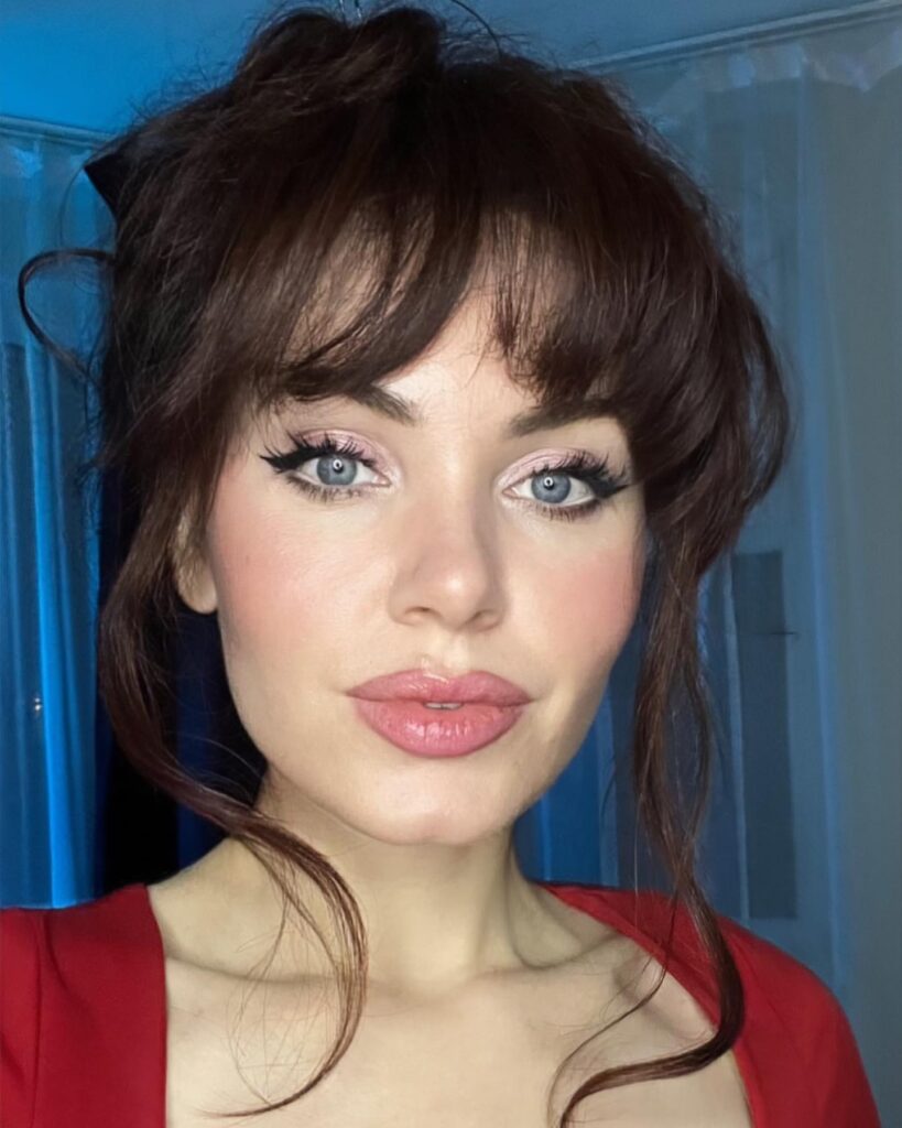 A Russian influencer and aspiring actress has gone viral with fans branding her the "Russian Angelina Jolie" after a black coat and bold makeup look racked up millions of views.