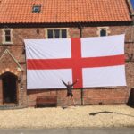 A lucky Brit has won a monster 24ft England flag wide enough to cover his entire house front - described as the length of three-and-a-half Peter Crouchs laid end to end.