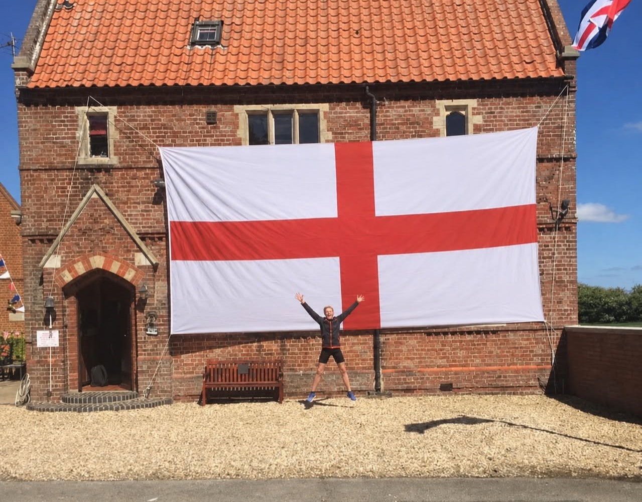 A lucky Brit has won a monster 24ft England flag wide enough to cover his entire house front - described as the length of three-and-a-half Peter Crouchs laid end to end.