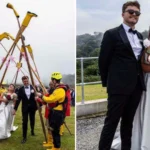 RNLI lifeboat crew surprised newlywed colleagues with a guard of honour made from gig boat oars and the charity's iconic yellow wellies after their Cornwall clifftop wedding.