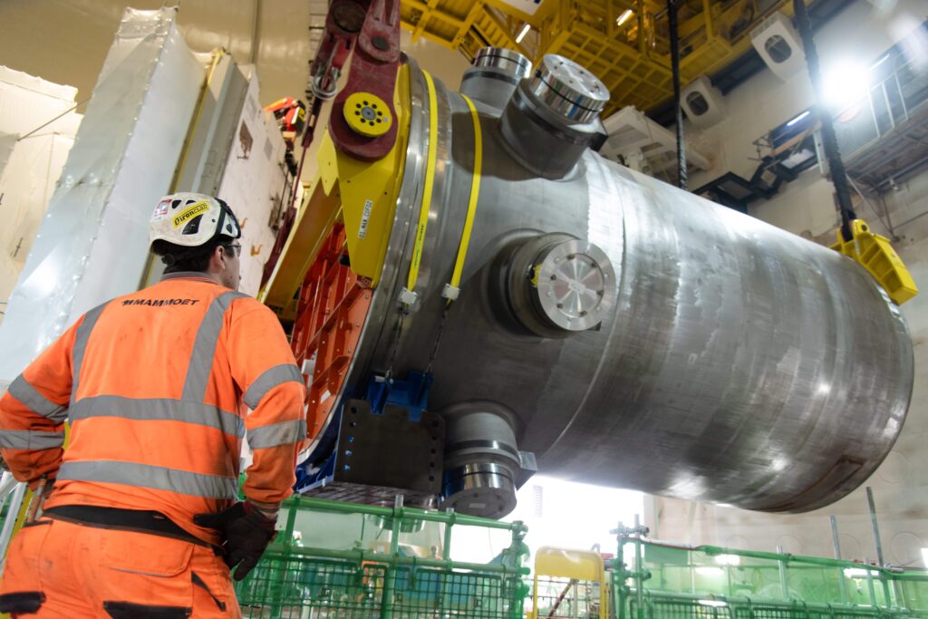World's biggest crane "Big Carl" completes huge milestone by lifting giant reactor into place at Britain's newest nuclear power station Hinkley Point C in Somerset.