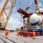 World's biggest crane "Big Carl" completes huge milestone by lifting giant reactor into place at Britain's newest nuclear power station Hinkley Point C in Somerset.