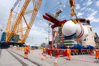 World's biggest crane "Big Carl" completes huge milestone by lifting giant reactor into place at Britain's newest nuclear power station Hinkley Point C in Somerset.