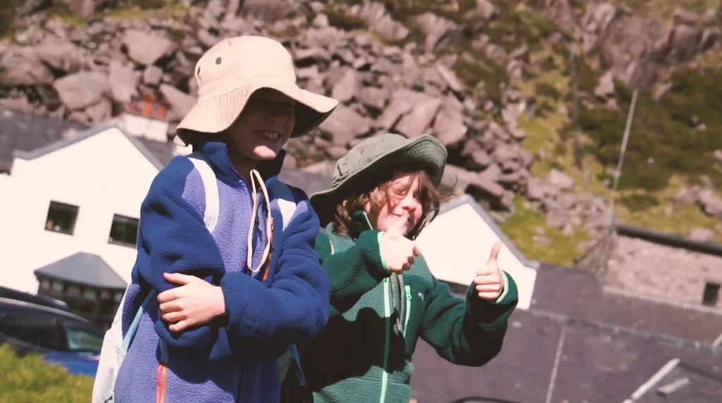 A seven-year-old and his 10-year-old brother took on the UK Three Peaks Challenge in 72 hours to raise money for their mum's Crohn's battle - and may bag a world record.