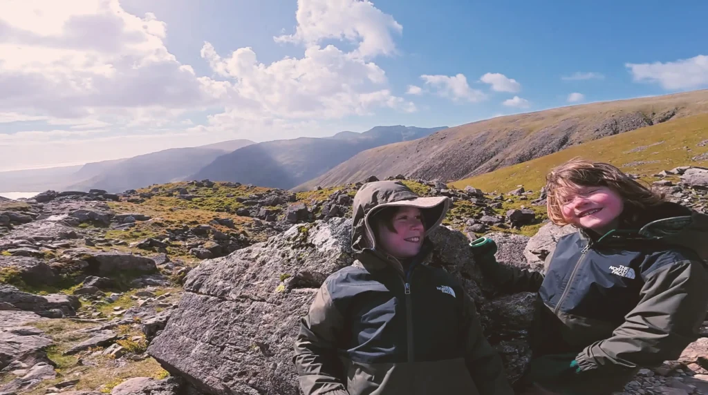 A seven-year-old and his 10-year-old brother took on the UK Three Peaks Challenge in 72 hours to raise money for their mum's Crohn's battle - and may bag a world record.