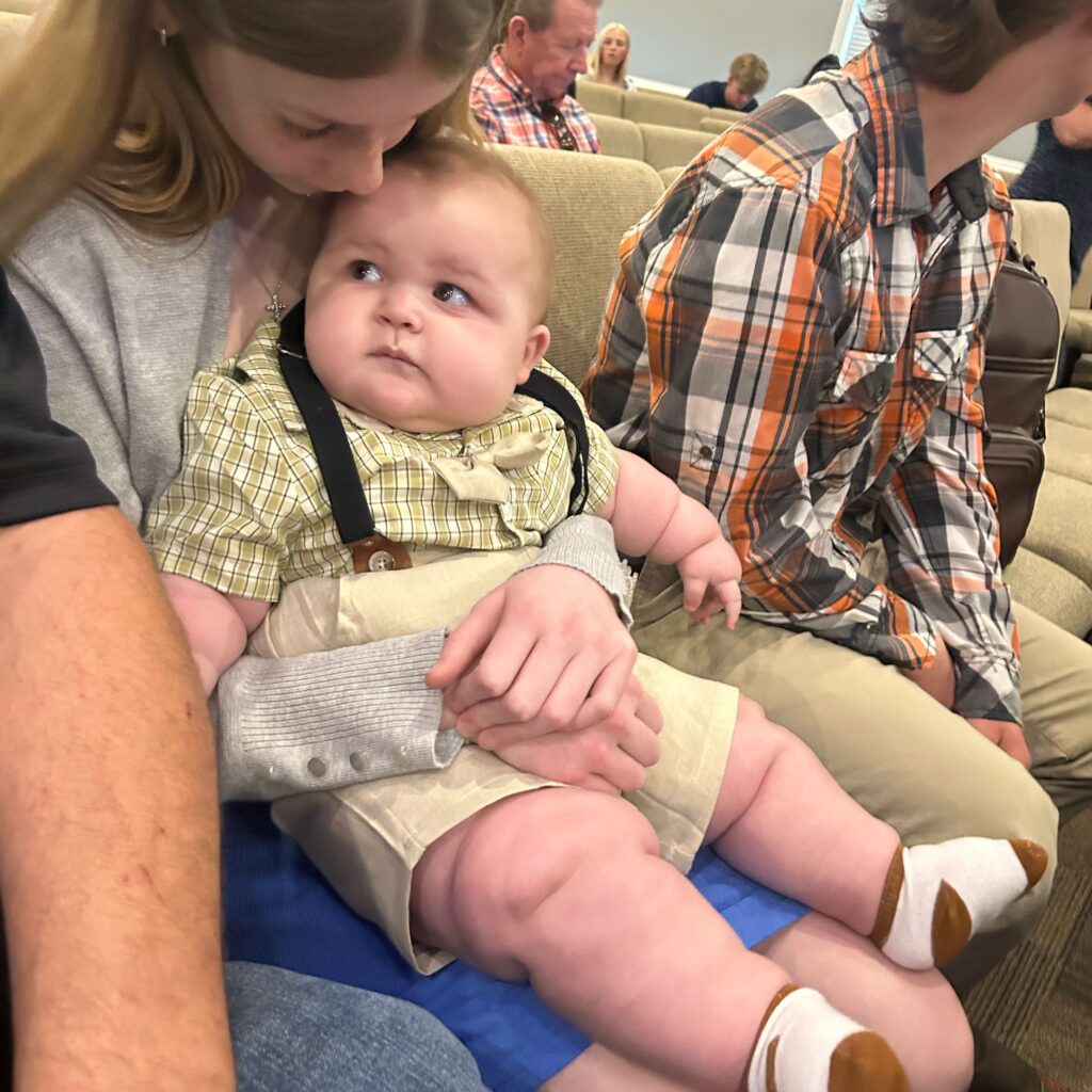 A mum says her eight-month-old baby is already wearing clothes for five-year-olds and has cost $5,000 in outgrown equipment - adding that she carries him "with hope and prayer".
