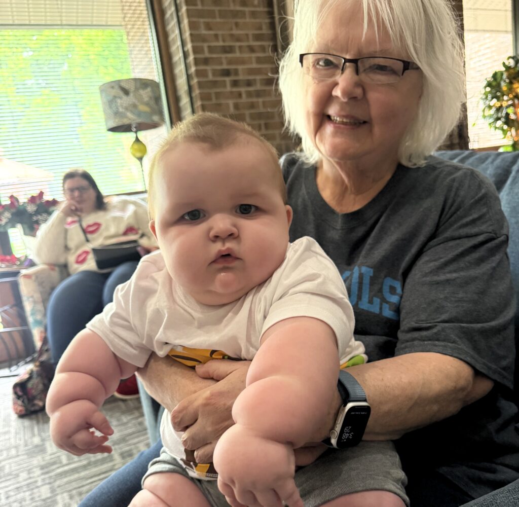 A mum says her eight-month-old baby is already wearing clothes for five-year-olds and has cost $5,000 in outgrown equipment - adding that she carries him "with hope and prayer".