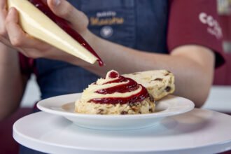 Costa Coffee brings back jam and cream scones after 5 years! Try the new 50/50 scone settling Britain's cream tea debate. Available now at 1000+ stores.