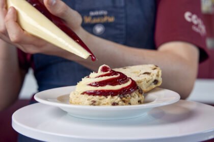 Costa Coffee brings back jam and cream scones after 5 years! Try the new 50/50 scone settling Britain's cream tea debate. Available now at 1000+ stores.