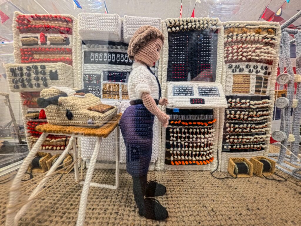 An extraordinary 80-metre exhibition depicting the D-Day landings, Spitfires and the Blitz has been created entirely from knitting and crochet by 200 volunteers.