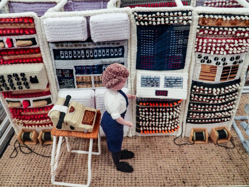 An extraordinary 80-metre exhibition depicting the D-Day landings, Spitfires and the Blitz has been created entirely from knitting and crochet by 200 volunteers.