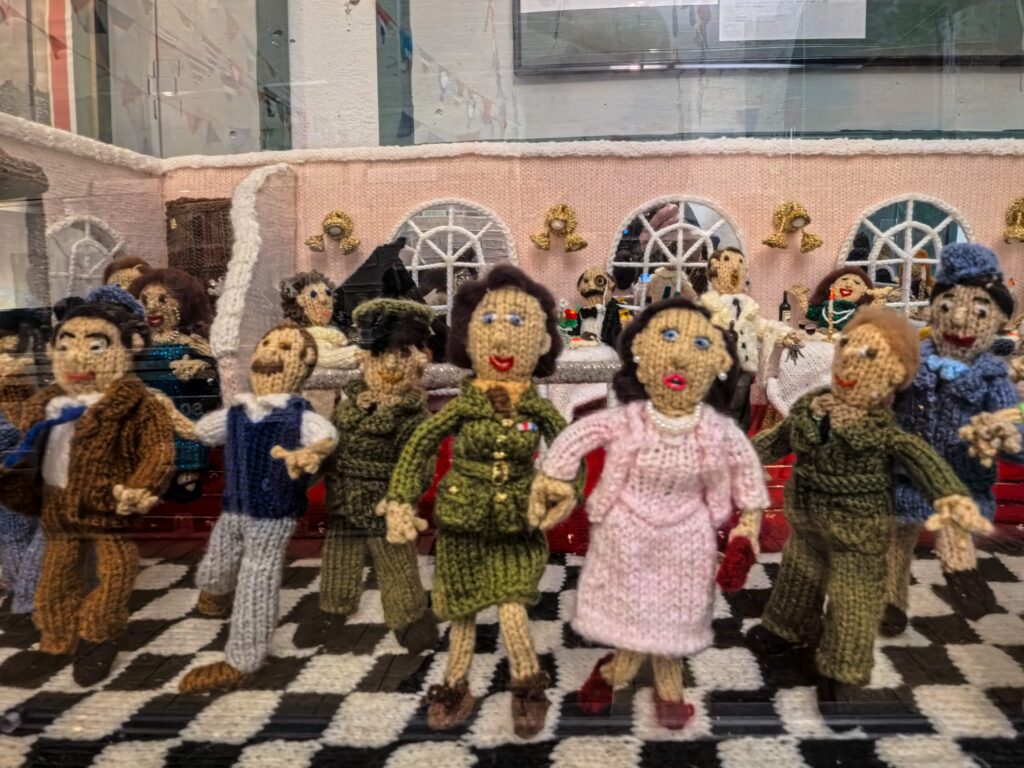 An extraordinary 80-metre exhibition depicting the D-Day landings, Spitfires and the Blitz has been created entirely from knitting and crochet by 200 volunteers.