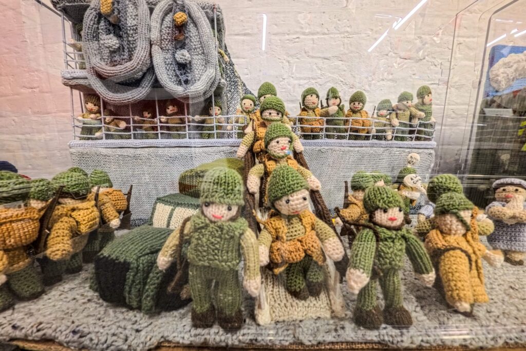An extraordinary 80-metre exhibition depicting the D-Day landings, Spitfires and the Blitz has been created entirely from knitting and crochet by 200 volunteers.