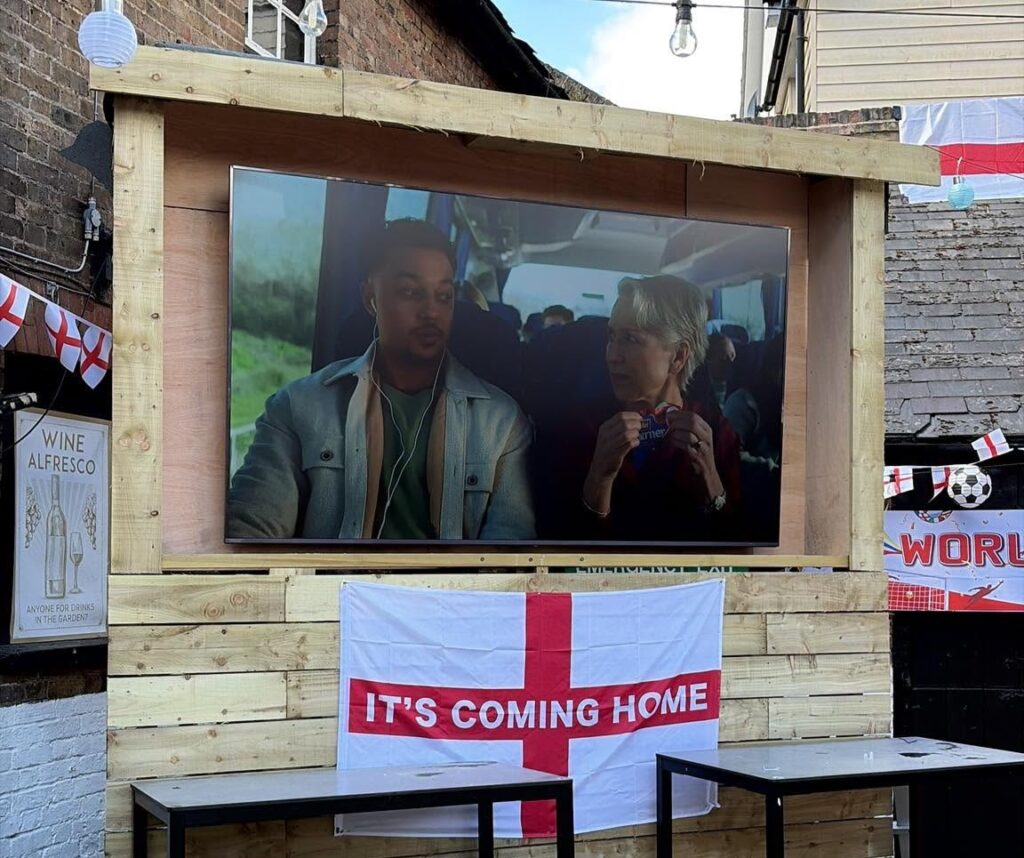 Pints fly as England fans erupt in a packed pub beer garden, celebrating a dramatic 3-2 World Cup win over Mexico that sends the Three Lions through to face Norway.