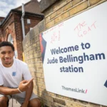 Jude Bellingham lookalike sparks chaos at a train station renamed in the star's honour, with fans mobbing him for selfies ahead of England's World Cup semi-final.