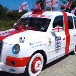 A dad-and-son duo have transformed an old London taxi into an England-themed supercar covered in St George's crosses and Three Lions badges for the World Cup.