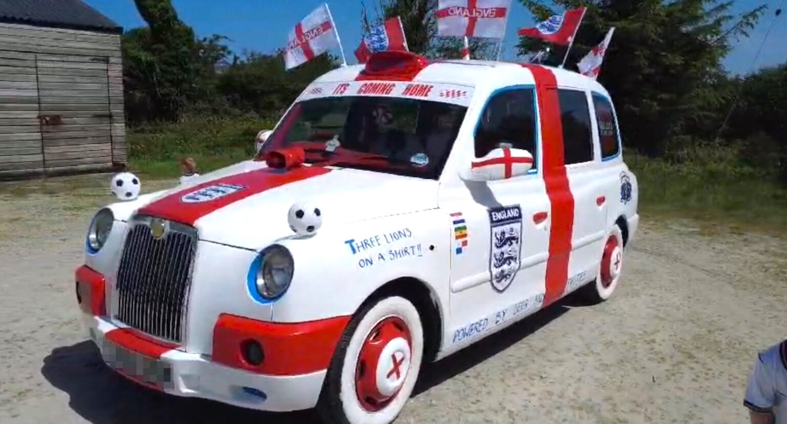 A dad-and-son duo have transformed an old London taxi into an England-themed supercar covered in St George's crosses and Three Lions badges for the World Cup.