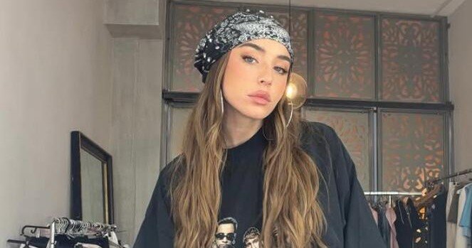 Reggaeton star Lola Indigo sent her wig flying with a dramatic head flick mid-performance in Ibiza - but the singer laughed it off and waved it at the cheering crowd like a pro.