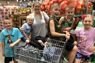 A YouTube mum of eight has revealed her family's eye-watering $15,000-a-month bills - yet still insists kids are 'cheap' and there's 'no excuse' not to have them.