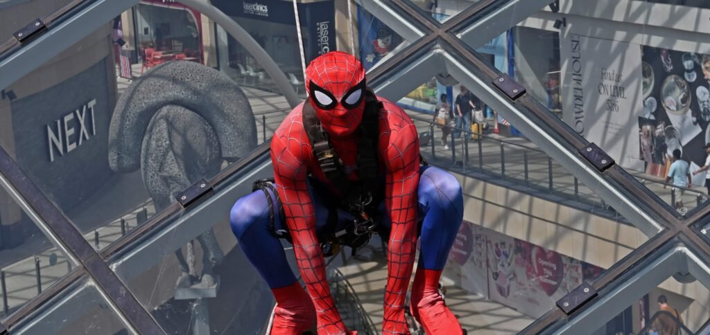 Shoppers did a double take after spotting "Spider-Man" scaling the vast glass dome of Trinity Leeds - but the web-slinger was really a window cleaner in costume.