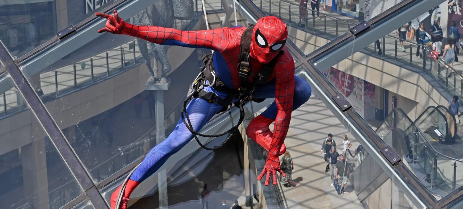 Shoppers did a double take after spotting "Spider-Man" scaling the vast glass dome of Trinity Leeds - but the web-slinger was really a window cleaner in costume.