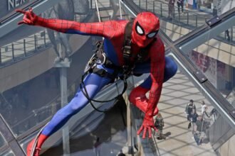 Shoppers did a double take after spotting "Spider-Man" scaling the vast glass dome of Trinity Leeds - but the web-slinger was really a window cleaner in costume.