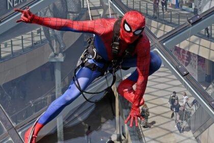 Shoppers did a double take after spotting "Spider-Man" scaling the vast glass dome of Trinity Leeds - but the web-slinger was really a window cleaner in costume.
