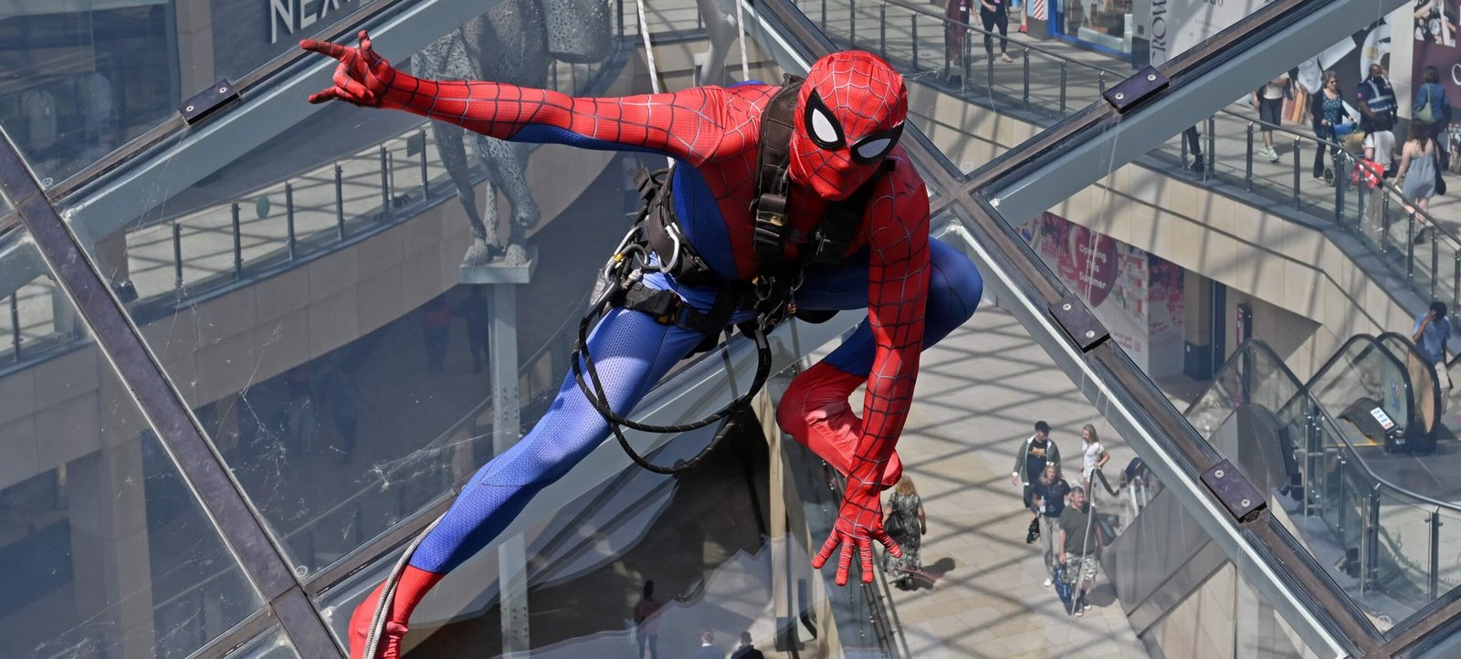 Mystery ‘Spider-Man' scales 130ft glass roof leaving baffled shoppers doing a double take