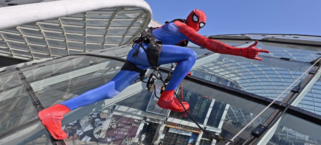 Shoppers did a double take after spotting "Spider-Man" scaling the vast glass dome of Trinity Leeds - but the web-slinger was really a window cleaner in costume.