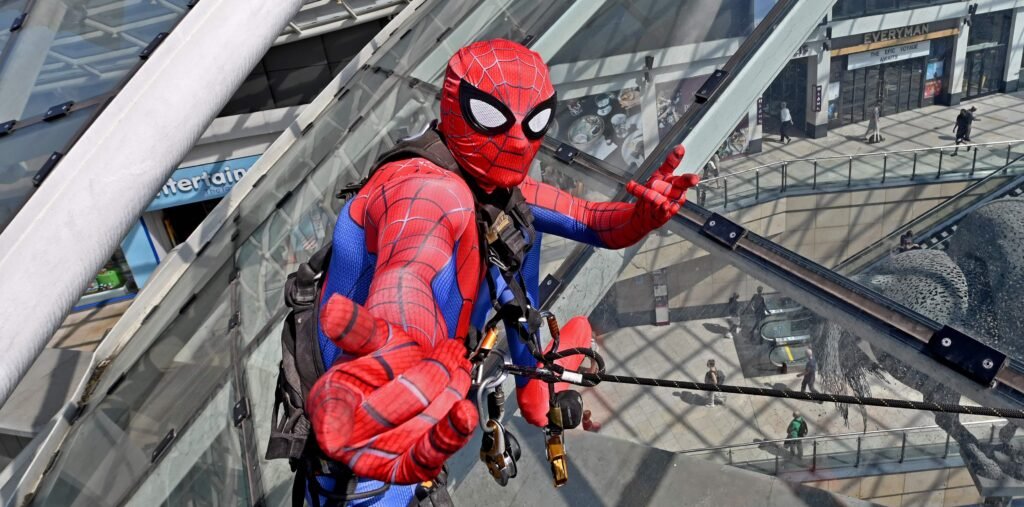 Shoppers did a double take after spotting "Spider-Man" scaling the vast glass dome of Trinity Leeds - but the web-slinger was really a window cleaner in costume.