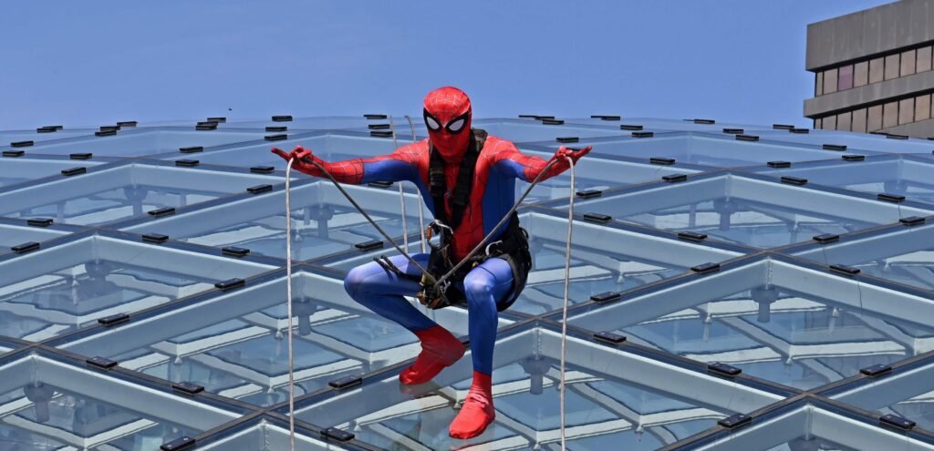 Shoppers did a double take after spotting "Spider-Man" scaling the vast glass dome of Trinity Leeds - but the web-slinger was really a window cleaner in costume.