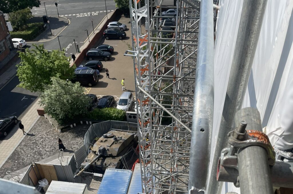 A roofer was left fighting back tears after uncovering a photo of his teenage son he had secretly hidden beneath a roof slate 24 years earlier - with his son working beside him.