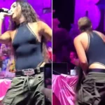 Reggaeton star Lola Indigo sent her wig flying with a dramatic head flick mid-performance in Ibiza - but the singer laughed it off and waved it at the cheering crowd like a pro.