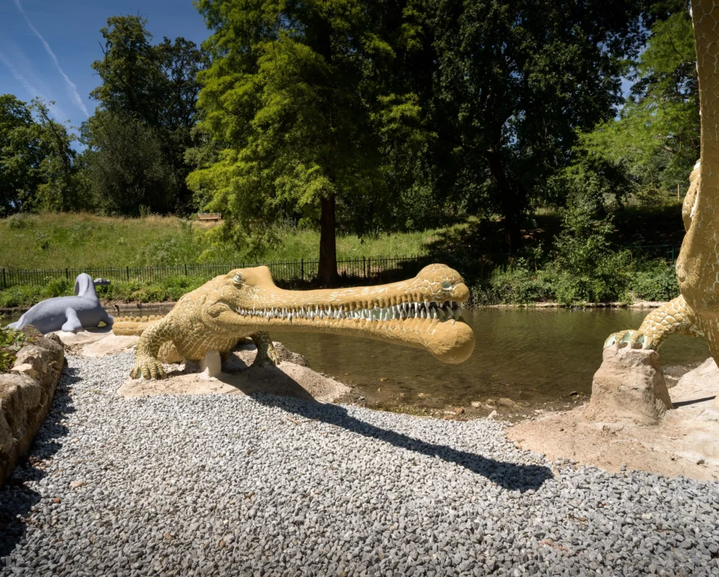 The world's first life-sized dinosaur sculptures have been saved from the at-risk register after a £27m project restored the 172-year-old Victorian icons.