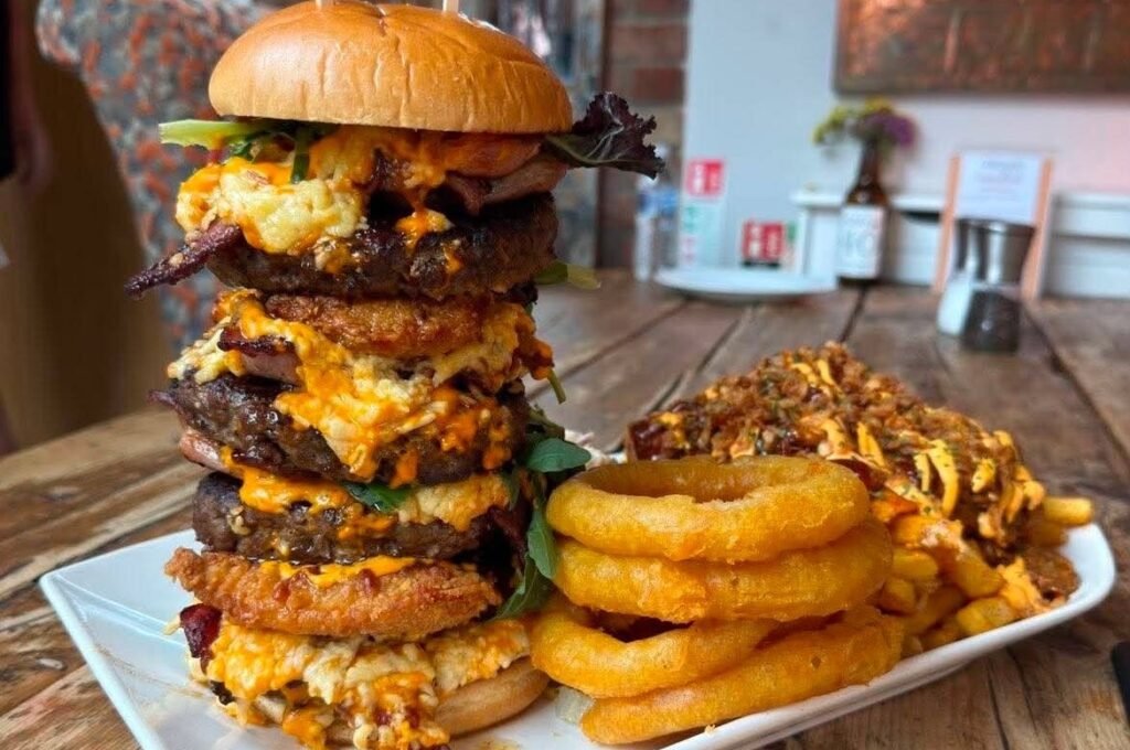 Brits have been beaten by one of the UK's biggest gut-busting burgers - a 5,000-calorie tower of beef, chicken, cheese, bacon and onion rings with a £100 prize.