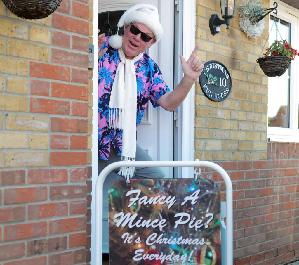 Man who has celebrated Christmas every day for 33 years says the heatwave made it 'unbearable' - so he now opens presents in a paddling pool.