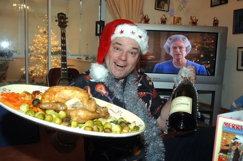 Man who has celebrated Christmas every day for 33 years says the heatwave made it 'unbearable' - so he now opens presents in a paddling pool.