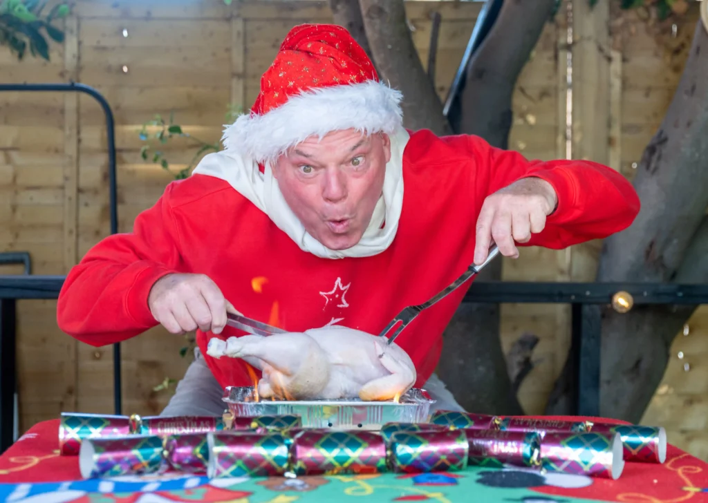 Man who has celebrated Christmas every day for 33 years says the heatwave made it 'unbearable' - so he now opens presents in a paddling pool.