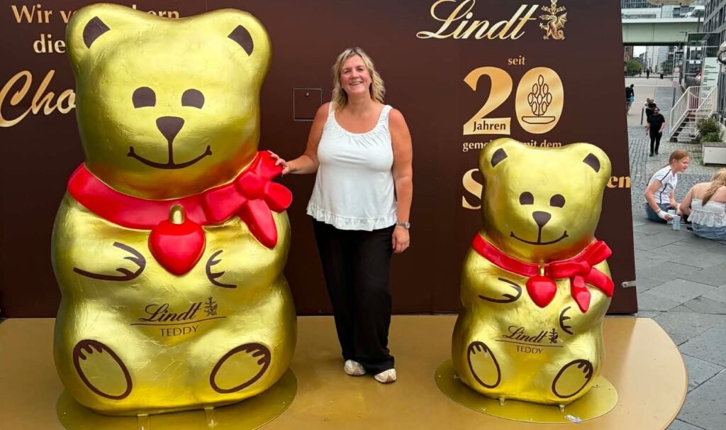 A woman inspired to make the most of life after losing her father before his retirement has visited 57 cities before her 50th birthday - on trips costing under £120.