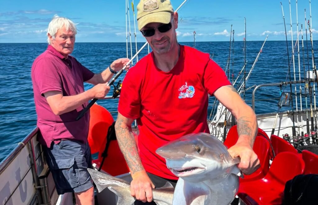 A monster shark believed to measure more than 25ft long has been spotted patrolling the waters off the Isle of Man - leaving stunned onlookers with jaws on the deck.