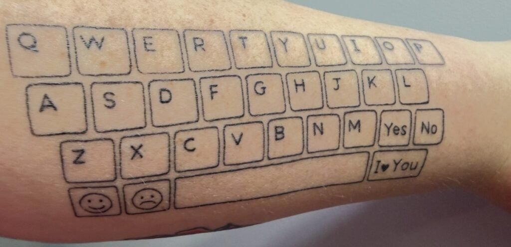 A devoted mum tattooed an entire keyboard on her arm so her non-speaking son can always talk to her - and his first typed words left her in tears.